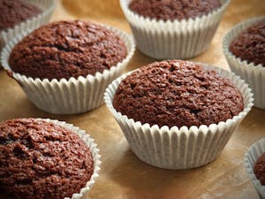Indulge in freshly baked chocolate muffins, perfect for dessert or a sweet snack at home.